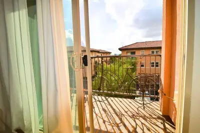 an open door to a balcony with a view of a building at Stylish 2BR Foothill Escape in Irvine in Lake Forest