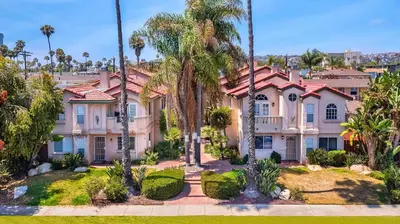 a row of houses with palm trees and landscaping at Coastal Villas Walk to the Beach 3 Homes Villa in San Diego