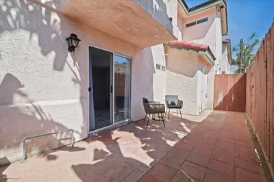 a patio with a table and chairs next to a building at Coastal Villas Walk to the Beach 3 Homes Villa in San Diego