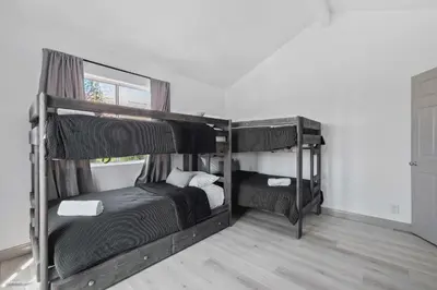 a bedroom with two bunk beds and a window at Coastal Villas Walk to the Beach 3 Homes Villa in San Diego