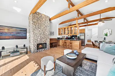 a living room with a white couch and a fireplace at Laguna Beach Coastal Cottage in Laguna Beach