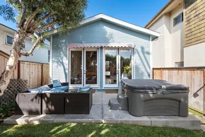 a backyard with a hot tub and a grill at Laguna Beach Coastal Cottage in Laguna Beach