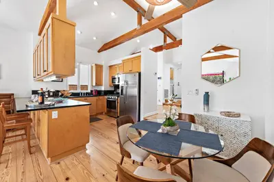 a kitchen and dining room with a table and chairs at Laguna Beach Coastal Cottage in Laguna Beach