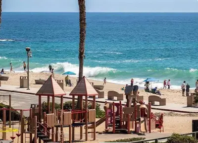 a beach with a playground and people on the beach at Laguna Beach Coastal Cottage in Laguna Beach