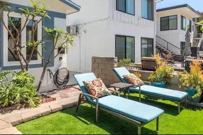 a patio with two blue chairs and plants at Roswitha's Blue Wave Cottage in San Diego