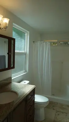 a bathroom with a toilet and a sink and a shower at Cozy 3-bedroom residential home in Wildomar, CA in Wildomar