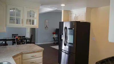 a kitchen with a black refrigerator and a dining room at Cozy 3-bedroom residential home in Wildomar, CA in Wildomar