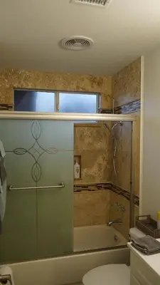 a bathroom with a tub and a toilet and a sink at Terrific 3-bedroom house with AC in Oceanside in Oceanside