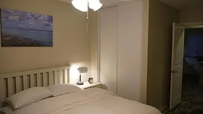 a bedroom with a bed and a lamp on a table at Terrific 3-bedroom house with AC in Oceanside in Oceanside