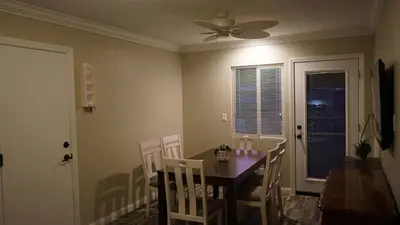a dining room with a table and chairs and a ceiling fan at Terrific 3-bedroom house with AC in Oceanside in Oceanside