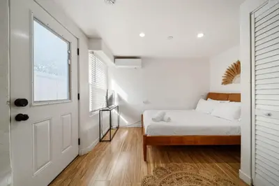 a bedroom with a bed and a window at Boho Little Italy Studio with Patio in San Diego