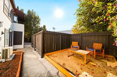 a backyard with two chairs and a table and a fence at Boho Little Italy Studio with Patio in San Diego