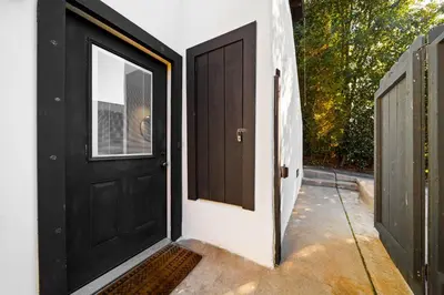 an open black door with a window on a house at Boho Little Italy Studio with Patio in San Diego