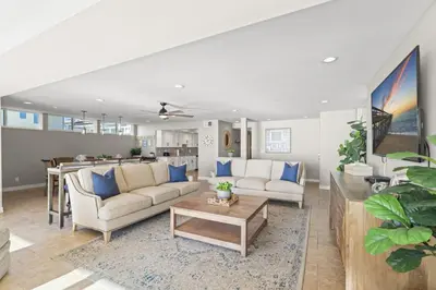 a living room with two couches and a table at Hawaiian Style Beachfront on Beach Road in Dana Point