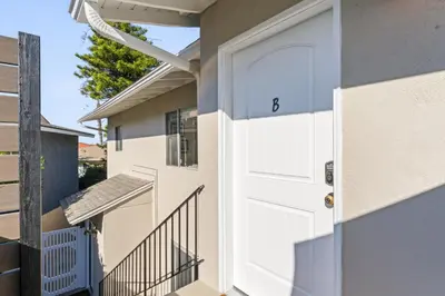 a white door on a house with a balcony at Hideaway ALL Walk to the Beach Downtown AC in San Clemente