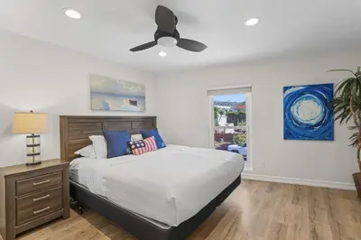 a bedroom with a bed and a ceiling fan at Hideaway ALL Walk to the Beach Downtown AC in San Clemente