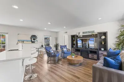 a living room with a couch and a table at Hideaway D Walk to the beach Downtown AC in San Clemente