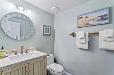 a bathroom with a sink and a toilet and a mirror at Coastal Duo Steps to Wedding Venues Beach Ole Hanson Casino in San Clemente