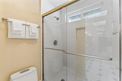 a bathroom with a glass shower with a toilet at Coastal Duo Steps to Wedding Venues Beach Ole Hanson Casino in San Clemente