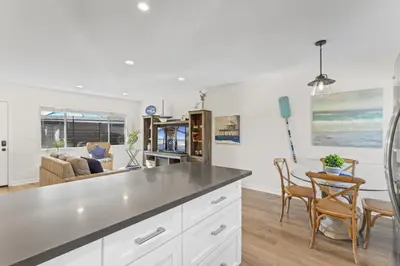 a kitchen and living room with a table and chairs at Hideaway C Walk to the beach Downtown AC in San Clemente