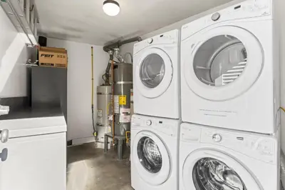 a laundry room with three washer and dryer machines at Hideaway C Walk to the beach Downtown AC in San Clemente