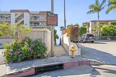a yellow fire hydrant on the side of a street at Hideaway C Walk to the beach Downtown AC in San Clemente