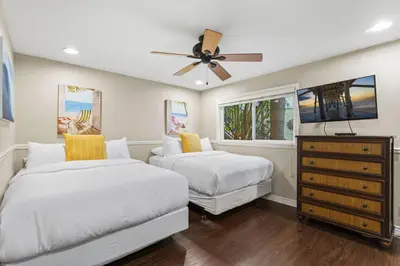 a bedroom with two beds and a ceiling fan at Coastal Duo Steps to Ole Hanson Casino and the beach in San Clemente