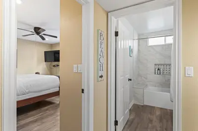 a bedroom with a bed and a bathroom with a tub at Coastal Duo Steps to Ole Hanson Casino and the beach in San Clemente