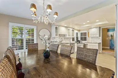 a kitchen and dining room with a table and chairs at 4BR Beach Condo Kids Hideaway Walk to Beach Casino Ole Hanson in San Clemente