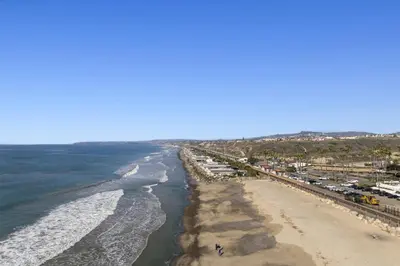 an aerial view of a beach and the ocean at 4BR Beach Condo Kids Hideaway Walk to Beach Casino Ole Hanson in San Clemente