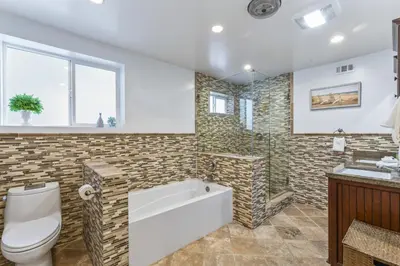 a bathroom with a tub and a toilet and a sink at Walk to the beach and Ole Hanson Casino Wedding Venues in San Clemente
