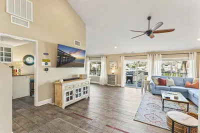 a living room with a blue couch and a table at Walk to the beach and Ole Hanson Casino Wedding Venues in San Clemente