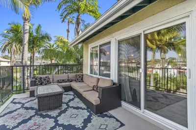 a screened porch with a couch and a fireplace at Walk to the beach and Ole Hanson Casino Wedding Venues in San Clemente