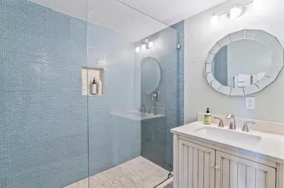 a bathroom with a shower and a sink and a mirror at Walk to the beach and Ole Hanson Casino Wedding Venues in San Clemente