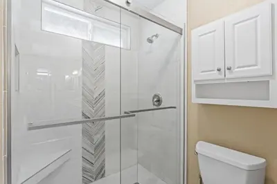 a bathroom with a glass shower with a toilet at Bright 3BR Beach Condo Near Casino and Ole Hanson in San Clemente