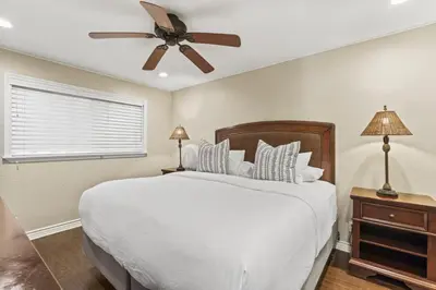a bedroom with a white bed and a ceiling fan at Tropical 2BR Retreat Walk to Beach Wedding Venues Large Deck in San Clemente