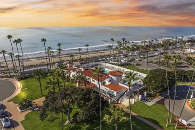 an aerial view of a resort with palm trees and the ocean at Tropical 2BR Retreat Walk to Beach Wedding Venues Large Deck in San Clemente