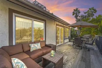 a living room with a couch and a patio at Walk to the Beach Wedding Venues Downtown Del Mar AC in San Clemente