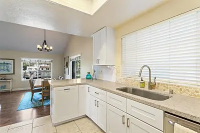 a kitchen with white cabinets and a sink at Walk to the Beach Wedding Venues Downtown Del Mar AC in San Clemente