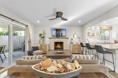 a living room with a couch and a fireplace at Hideaway A Walk to the beach Downtown AC in San Clemente
