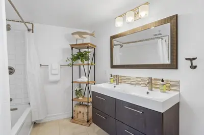 a bathroom with a sink and a mirror at Hideaway A Walk to the beach Downtown AC in San Clemente