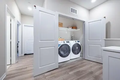 a white laundry room with a washer and dryer at Chula Vista 3BR with Children's Playroom, Pool, Park and Sleeps 9 in Chula Vista