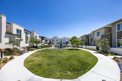 a park in the courtyard of a apartment building at Chula Vista 3BR with Children's Playroom, Pool, Park and Sleeps 9 in Chula Vista