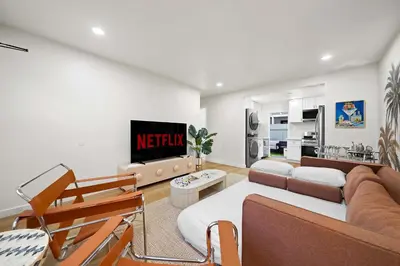 a living room with a couch and a tv at Explore North Park Chic 2br with Fire Pit Sleeps 6 in San Diego
