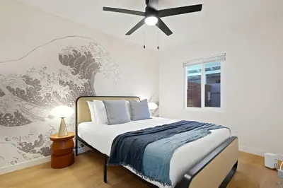 a bedroom with a bed and a ceiling fan at Explore North Park Chic 2br with Fire Pit Sleeps 6 in San Diego