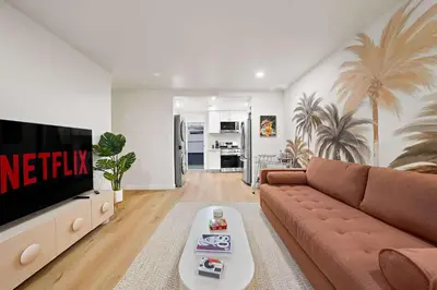 a living room with a couch and a tv at Explore North Park Chic 2br with Fire Pit Sleeps 6 in San Diego