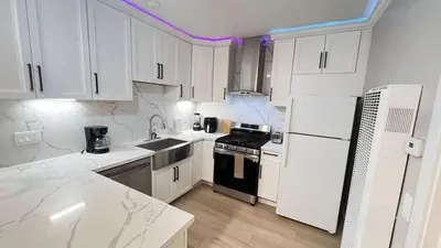 a kitchen with white cabinets and a black stove at 8354 Adam Unit B 1Bed 1Bath by SD Stay in Lemon Grove