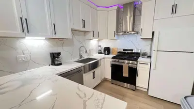 a kitchen with white cabinets and a sink and a refrigerator at 8354 Adam Unit B 1Bed 1Bath by SD Stay in Lemon Grove