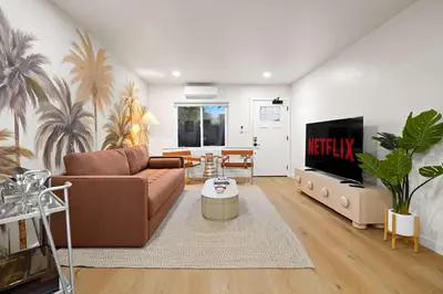 a living room with a couch and a tv at Stylish 2BR SD Retreat Firepit plus Outdoor Lounge in San Diego