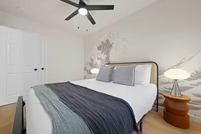 a bedroom with a bed with a ceiling fan at Stylish 2BR SD Retreat Firepit plus Outdoor Lounge in San Diego
